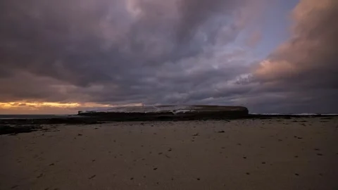 4K Time lapse of the brough of birsay covered in snow during sunset Stock Footage 297282129