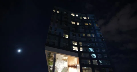 4K TIME LAPSE OF BUILDING AT NIGHT WITH CLOUDS AND MOON Stock Footage 132080757