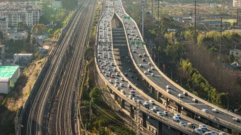 4K Time-lapse of Busy Road and Railway Traffic at Urban Interchange Stock-Footage 341788943