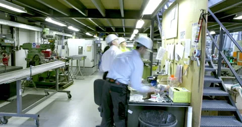4K Time lapse of busy workers in the office section of a warehouse or factory Stock Footage 67147840