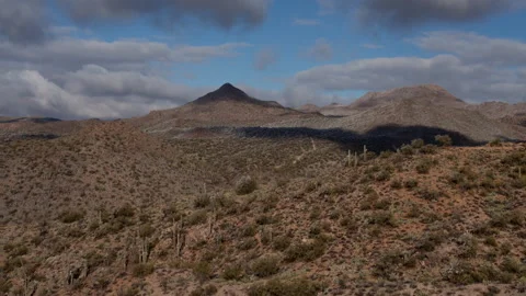 4K Time lapse of clouds in blue sky casting shadows on desert hills in Arizona Stock Footage 147097692