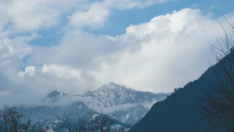4K Time lapse of clouds covering the snow covered mountain during the snowfall  Stock Footage 168292228