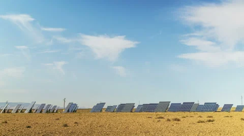 4k Time lapse of clouds float above a moving solar farm. Stock Footage 46747979