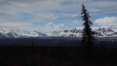 4K time lapse of clouds flowing around snowy mountains in the Alaska Range Stock Footage 242483546