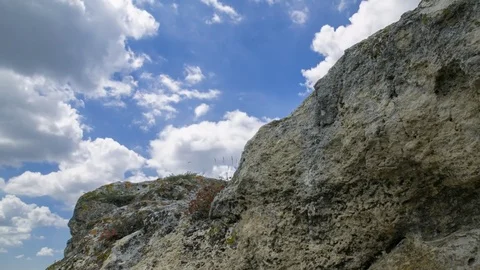 4k time lapse of clouds mass rolling over rocks Stock Footage 77093793
