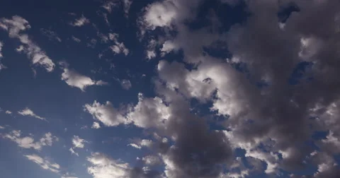4K Time-lapse of clouds moving across a blue sky Stock Footage 64694657
