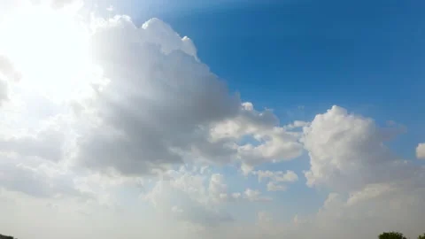 4K Time lapse of the clouds in the sky with sun beams shining  Stock Footage 155298604