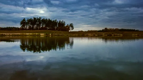 4k time lapse with cloudy morning sky over small lake. Stock Footage 154351557