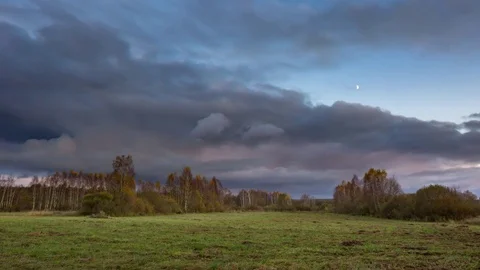 4k time-lapse with cloudy sky with moon over autumnal wild meadow in Poland Stock Footage 81605851