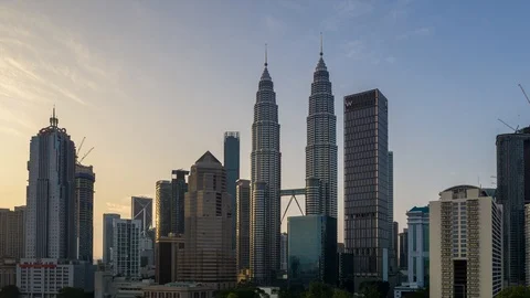 4K Time lapse of cloudy sunrise over downtown Kuala Lumpur, Malaysia. Zoom In. Stock Footage 90799866