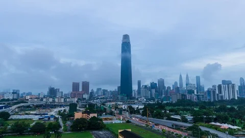 4K Time lapse of cloudy sunrise over Exchange 106 tower. Zoom In Stock Footage 97858979