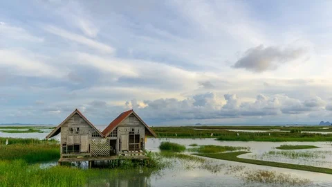 4K Time lapse of cloudy sunset over abandoned house at lake Thale Noi. Stock Footage 96339921