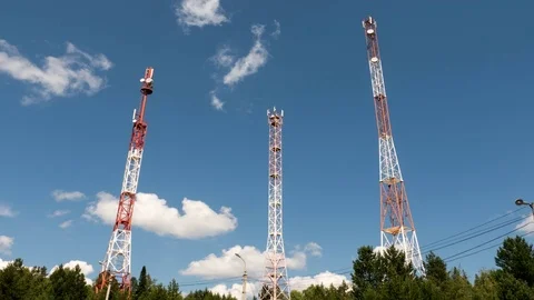 4k Time lapse of cumulus clouds over 3 cell towers Stock Footage 79727381