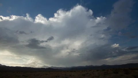 4K time lapse of a dissipating summer desert storm backlit by afternoon sunlight Stock Footage 204885593