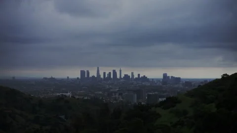 4K Time-lapse of Downtown Los Angeles Skyline framed by mountains with clouds Stock Footage 219349962