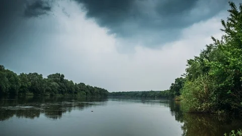 4K Time Lapse of dramatic Clouds move fast above river in rainy weather, beauty Stock Footage 90224619