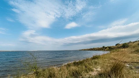4K time lapse of the estuary in cloudy weather. Timelapse of the sea in cloudy Stock Footage 117972362