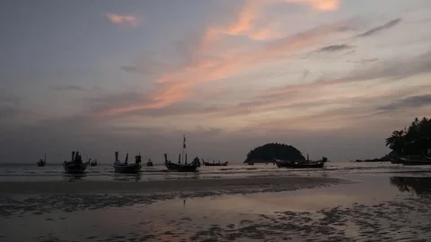 4K Time - lapse group of long tail boat with sunset at kata bech , PHUKET T.. Video stock 74127251