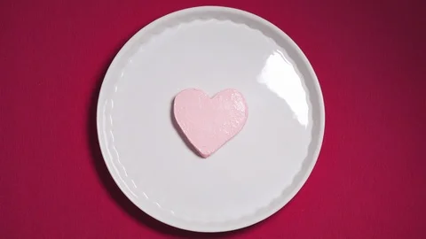 4K Time lapse heart-shaped ice-cream melting on pink background. Top view Video stock 121727747