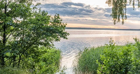 4K Time Lapse of lake. Green Forest. Wonderful green forest over the lake in Stock Footage 135028322