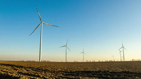 4k time lapse landscape with plowed field and windmills in sunset light. Stock Footage 164303154