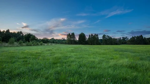 4k time lapse landscape with sunset sky over green meadow 動画素材 79939295