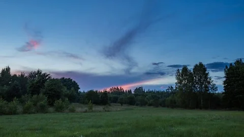  4k time lapse landscape with sunset sky over green meadow. Stock Footage 80013742