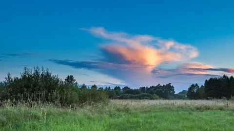 4k time lapse landscape with sunset sky over green meadow Stock Footage 80046911