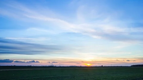 4k time-lapse landscape of vibrant sunset sky over field in springtime Video stock 73687476