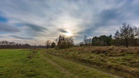 4k time lapse landscape with wild meadow under blurry clouds at springtime. Stock Footage 83564872