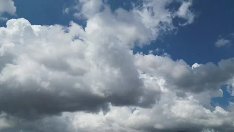 4K Time-lapse of Large Puffy Cumulus Clouds Rolling in Blue Sky Stock Footage 321679351