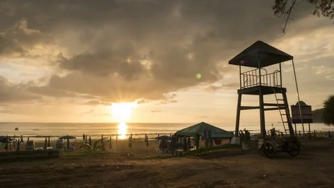 4K Time - lapse life guard tower on the beach with cloud movement and sunset  Stock Footage 74128312