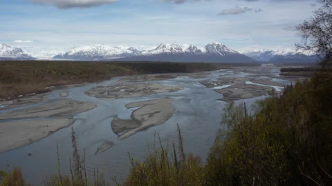 4K time lapse of low spring clouds hiding the snowy peak of Denali in Alaska Video stock 242884454