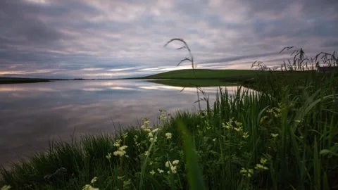 4k Time Lapse of Mirror reflections in Blue Hour Over the Skaill Loch  動画素材 253320697
