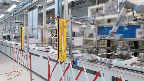 4K time-lapse of a modern industrial line production, robots and humans at work Stock Footage