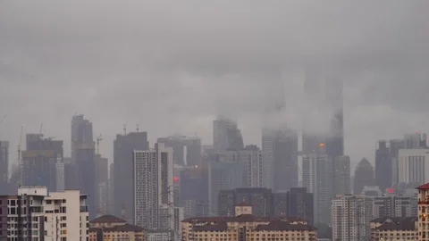 4K time lapse of monsoon rain over down town Kuala Lumpur, Malaysia. Zoom Out Stock Footage 128998677