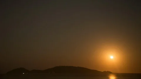 4K Time lapse of Moon rising behind an island Stock Footage 90069266