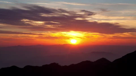 4K Time Lapse Of Mountain Ridges Silhouetted By colorful Sunset clouds Stock Footage 147906888