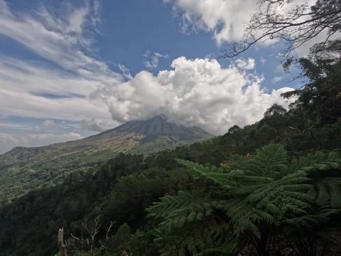 4k time lapse with the movement of clouds over the top of a volcano Stock Footage 245332146