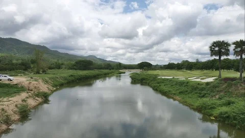 4K Time-lapse the movements of clouds,tree and river Stock Footage 76451632