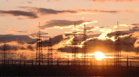4K TIME LAPSE of moving clouds in front of a sunset and utility poles Stock Footage 63481313