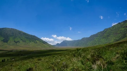 4K Time lapse of moving clouds over mountains at savanna of Bromo. Zoom In Stock Footage 88950462