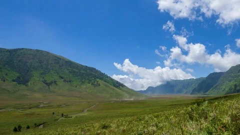 4K Time lapse of moving clouds over mountains at savanna of Bromo. Zoom In. Stock Footage 88950464