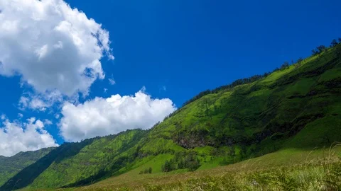 4K Time lapse of moving clouds over mountains at savanna of Bromo. Zoom In. Stock Footage 88952832