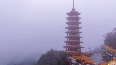 4K Time lapse of moving clouds and fog over Chin Swee Caves Temple in Malaysia. Stock Footage 89951633