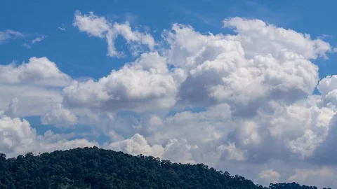 4K Time lapse of moving clouds over mountain. Zoom In Stock Footage 97647312