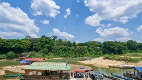 4K Time lapse of moving clouds over boat jetty on Tembeling river, Malaysia. Stock Footage 105275881