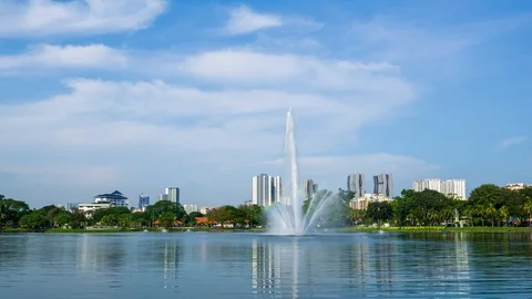 4K Time lapse of moving clouds over Taman Tasik Titiwangsa. Zoom In Stock Footage 121996770