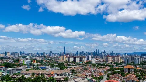 4K Time lapse of moving fluffy monsoon clouds  over downtown Kuala Lumpur. Stock Footage 107461335
