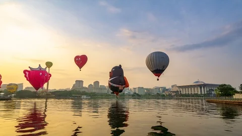 4K Time lapse of moving hot balloons over lake Putrajaya, Malaysia. Stock Footage 105442433